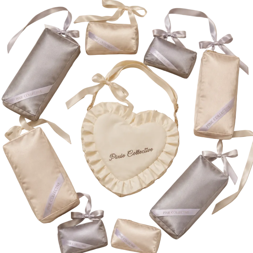 Pixie Collective gift set including a cream heart-shaped bag and matching silver and cream purse pillows in various sizes